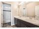 Bathroom featuring double sinks with marble countertops, black cabinetry, and a tiled shower/bath at 15437 W 95Th Ave, Arvada, CO 80007