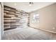Charming bedroom featuring a unique wood accent wall, plush carpeting, and a bright window at 15437 W 95Th Ave, Arvada, CO 80007