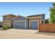Two-story home featuring a blue and beige exterior, a well-kept lawn, and a private wooden fence at 15437 W 95Th Ave, Arvada, CO 80007