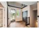 Bright foyer with hardwood floors, an open door, and a view to the outside at 15437 W 95Th Ave, Arvada, CO 80007