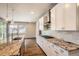 Modern kitchen featuring granite countertops, stainless steel appliances, and white cabinetry at 15437 W 95Th Ave, Arvada, CO 80007