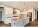 Modern kitchen featuring an island, granite countertops, stainless steel appliances and white cabinets at 15437 W 95Th Ave, Arvada, CO 80007
