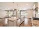 Open-concept kitchen with a center island, stainless steel dishwasher and views of the living area at 15437 W 95Th Ave, Arvada, CO 80007