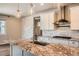 Close-up of modern kitchen island with granite countertops and a stainless steel faucet at 15437 W 95Th Ave, Arvada, CO 80007
