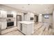 Open-concept layout features modern kitchen with island and basement living area at 15437 W 95Th Ave, Arvada, CO 80007