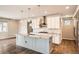 Modern kitchen with white cabinets, granite countertops, and stainless steel appliances at 15437 W 95Th Ave, Arvada, CO 80007