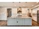 Spacious kitchen featuring a large island, modern lighting, and stainless steel appliances at 15437 W 95Th Ave, Arvada, CO 80007