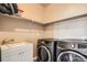 Well-organized laundry room features modern washer and dryer, ample storage, and utility sink at 15437 W 95Th Ave, Arvada, CO 80007