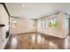 Spacious living room with hardwood floors, ample natural light, and a cozy fireplace at 15437 W 95Th Ave, Arvada, CO 80007