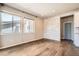 Spacious living room with hardwood floors, large windows, and a stacked stone accent wall at 15437 W 95Th Ave, Arvada, CO 80007