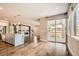 Bright open concept living room with an island and sliding glass doors to an outdoor deck at 15437 W 95Th Ave, Arvada, CO 80007