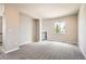 Bright living room with neutral walls, plush carpeting, and a large window offering natural light at 15437 W 95Th Ave, Arvada, CO 80007