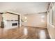 Bright open-concept living room with hardwood floors and a fireplace at 15437 W 95Th Ave, Arvada, CO 80007