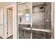 Modern shower with sleek tile, a built-in bench, and glass doors offers a spa-like experience at 15437 W 95Th Ave, Arvada, CO 80007
