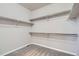 Spacious walk-in closet with ample shelving and neutral carpet, provides a customizable storage solution at 15437 W 95Th Ave, Arvada, CO 80007