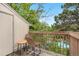 Outdoor balcony with two seats overlooking lush greenery and a pool at 3050 W 107Th Pl # E, Westminster, CO 80031