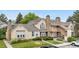 Exterior view of a multi-Gathering home featuring well-manicured landscaping and a stone chimney at 3050 W 107Th Pl # E, Westminster, CO 80031
