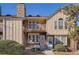 Exterior elevation of a two-story home with a stone chimney and front balcony at 3050 W 107Th Pl # E, Westminster, CO 80031