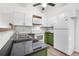 Modern kitchen featuring white cabinets, green lowers, and a sleek black countertop at 3050 W 107Th Pl # E, Westminster, CO 80031