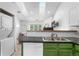 Kitchen featuring stainless steel appliances, green lowers and black countertops at 3050 W 107Th Pl # E, Westminster, CO 80031