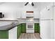 Updated kitchen with stainless sink, dishwasher, white appliances, and green cabinets at 3050 W 107Th Pl # E, Westminster, CO 80031