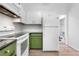 A bright kitchen features white cabinets and appliances, and green lowers at 3050 W 107Th Pl # E, Westminster, CO 80031