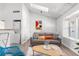 Cozy living room with a washer/dryer, a skylight, a comfortable sofa, and modern decor, perfect for relaxing at 3050 W 107Th Pl # E, Westminster, CO 80031