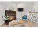 Inviting living room with fireplace, TV, stylish furniture, and bar seating, perfect for relaxing and entertaining at 3050 W 107Th Pl # E, Westminster, CO 80031