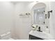 Stylish half bathroom featuring modern sink and gold-tone accents at 300 N Inca St, Denver, CO 80223