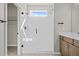 Bathroom featuring a walk-in shower with glass door and black hardware at 21044 E 63Rd Dr, Aurora, CO 80019