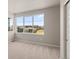 Bedroom with carpet, neutral colored walls and a large window with neighborhood views at 21044 E 63Rd Dr, Aurora, CO 80019