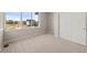 Bedroom with carpet, neutral colored walls, a large window and a closet with sliding doors at 21044 E 63Rd Dr, Aurora, CO 80019
