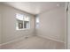 Bedroom featuring carpet, neutral colored walls and windows overlooking the neighborhood at 21044 E 63Rd Dr, Aurora, CO 80019
