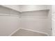 Walk-in closet featuring carpet, neutral colored walls, and white shelving and clothing rods at 21044 E 63Rd Dr, Aurora, CO 80019