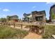 View of community garden with planting beds and a charming wooden fence at 21044 E 63Rd Dr, Aurora, CO 80019