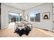 Charming dining area with a round table, stylish chairs, and sliding doors to the outdoor patio at 21044 E 63Rd Dr, Aurora, CO 80019