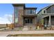 Charming two-story home with a stone facade, complemented by modern windows and professional landscaping at 21044 E 63Rd Dr, Aurora, CO 80019