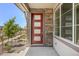Close up of a modern red front door with glass panels and stone detailing at 21044 E 63Rd Dr, Aurora, CO 80019