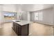 Modern kitchen features an island with stainless steel appliances and plenty of natural light at 21044 E 63Rd Dr, Aurora, CO 80019