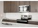 The kitchen features stainless steel appliances, stylish cabinetry, and a modern aesthetic at 21044 E 63Rd Dr, Aurora, CO 80019