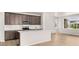 Modern kitchen boasts stainless steel appliances, granite countertops, and a center island at 21044 E 63Rd Dr, Aurora, CO 80019