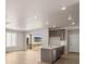 Modern kitchen features a central island with stainless steel appliances and an abundance of natural light at 21044 E 63Rd Dr, Aurora, CO 80019