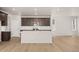 Spacious kitchen boasts an island with sleek appliances and ample cabinet space for a modern design at 21044 E 63Rd Dr, Aurora, CO 80019