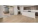 Open concept kitchen and dining area with hardwood floors and access to outdoor patio at 21044 E 63Rd Dr, Aurora, CO 80019