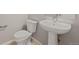 Stylish powder room with pedestal sink and toilet at 21044 E 63Rd Dr, Aurora, CO 80019