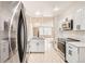 Open concept kitchen featuring stainless steel appliances, updated cabinets and hardwood floors at 7373 E Iowa Ave # 1112, Denver, CO 80231
