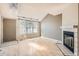 Bright living room with fireplace, skylight, and light wood floors at 7373 E Iowa Ave # 1112, Denver, CO 80231