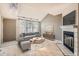 Bright living room featuring hardwood floors, fireplace, large windows and neutral décor at 7373 E Iowa Ave # 1112, Denver, CO 80231