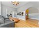 Cozy living area featuring hardwood floors, soft gray walls, and an open kitchen view at 1640 N Downing St # 103, Denver, CO 80218