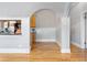 Elegant space with hardwood floors, neutral gray walls, and modern archway to the kitchen at 1640 N Downing St # 103, Denver, CO 80218